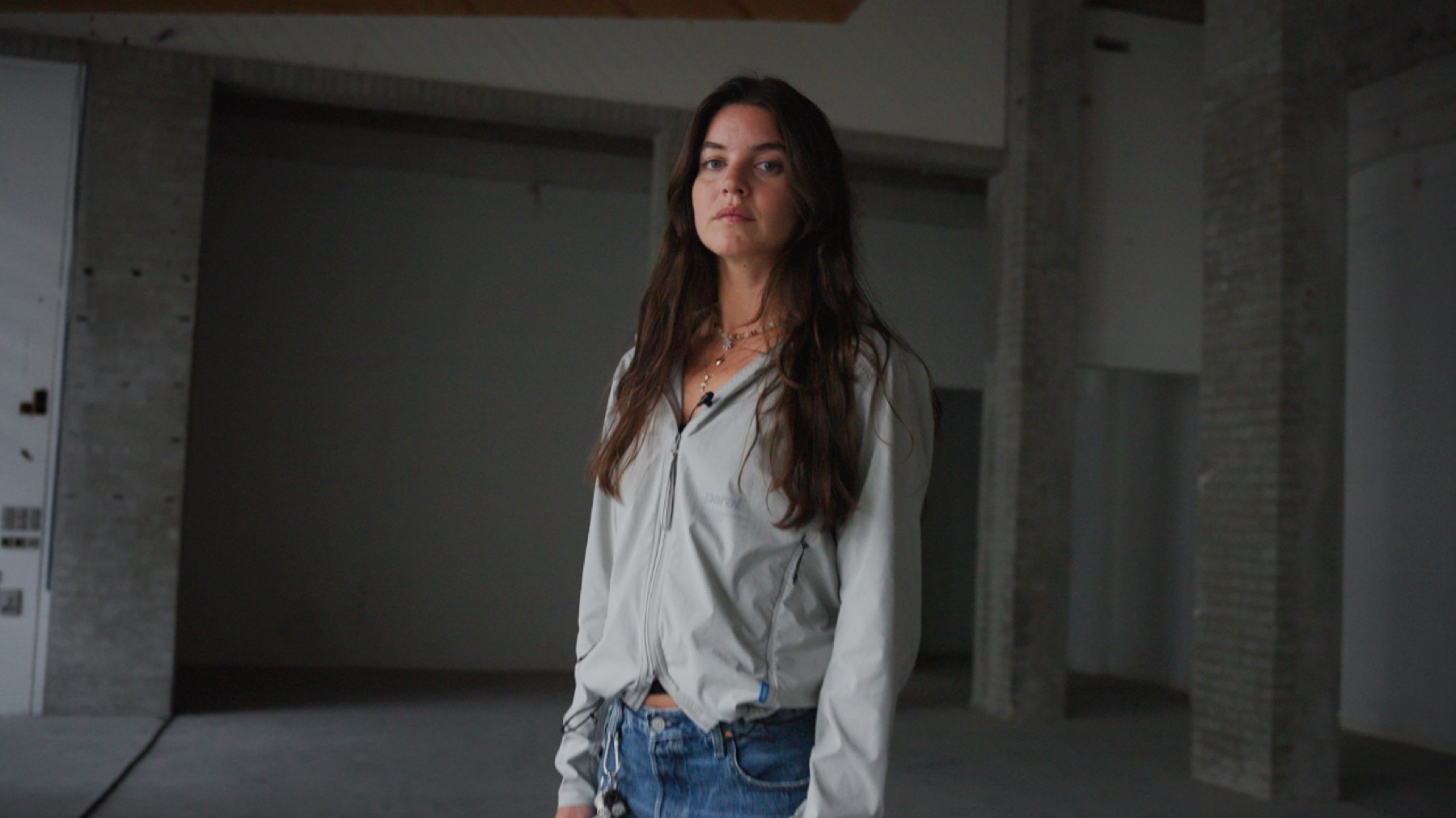 Dia standing in an unfinished industrial interior