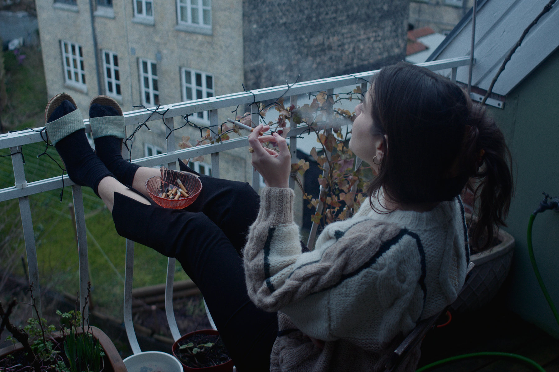 Karen smoking on a balcony in Hysterisk