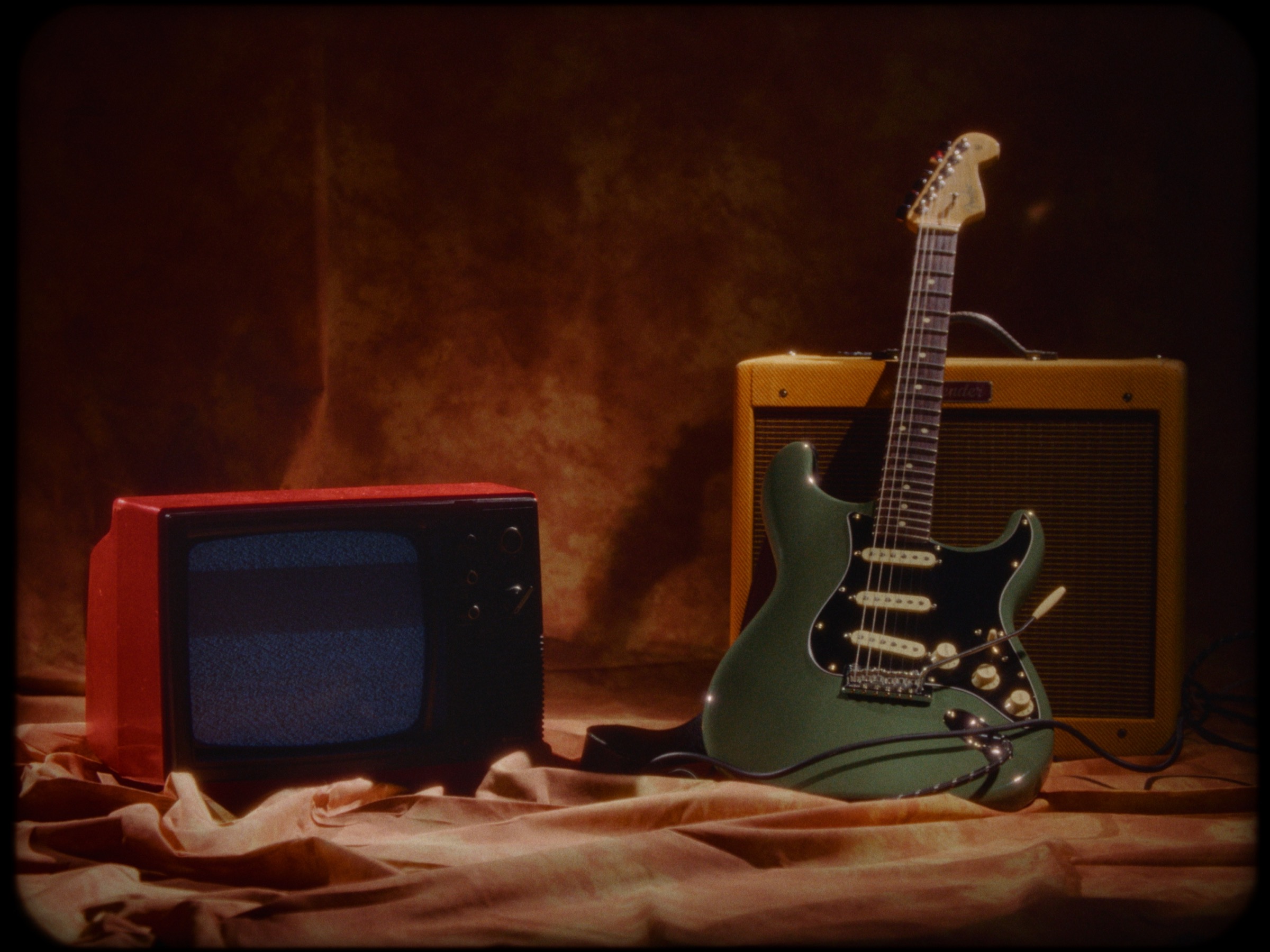 Vintage television, guitar and amplifier from the Dreamer music video